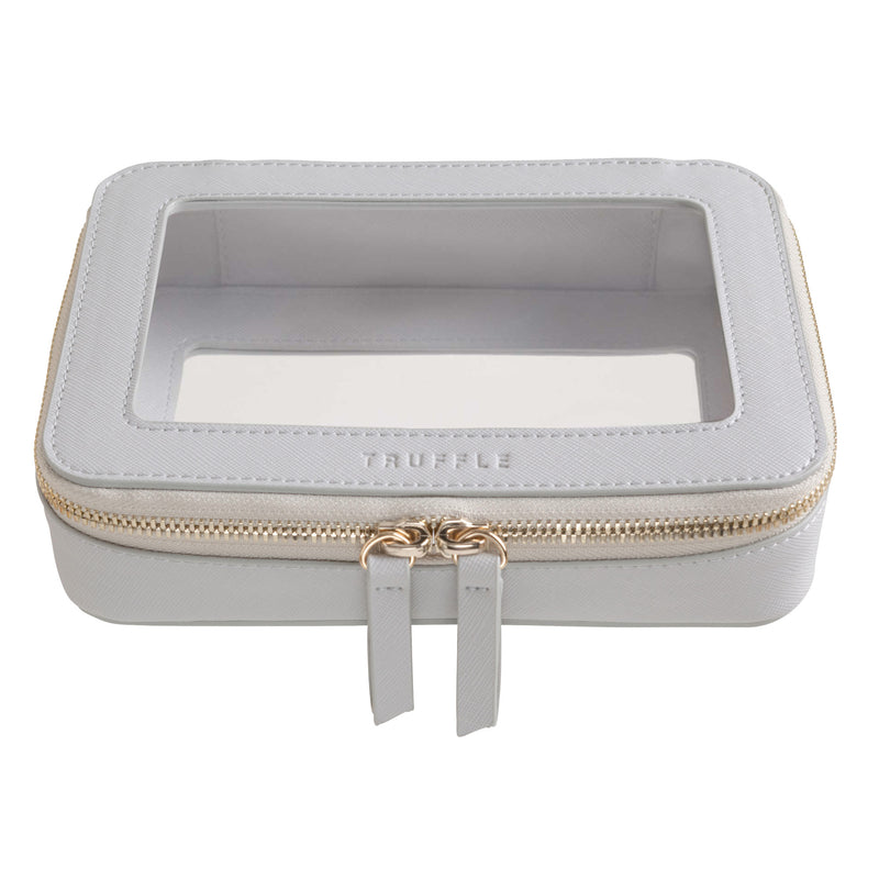 Truffle Clarity Jetset Case in dove grey leather, TSA approved for travel-sized liquids. Multipurpose for tech or makeup organization.