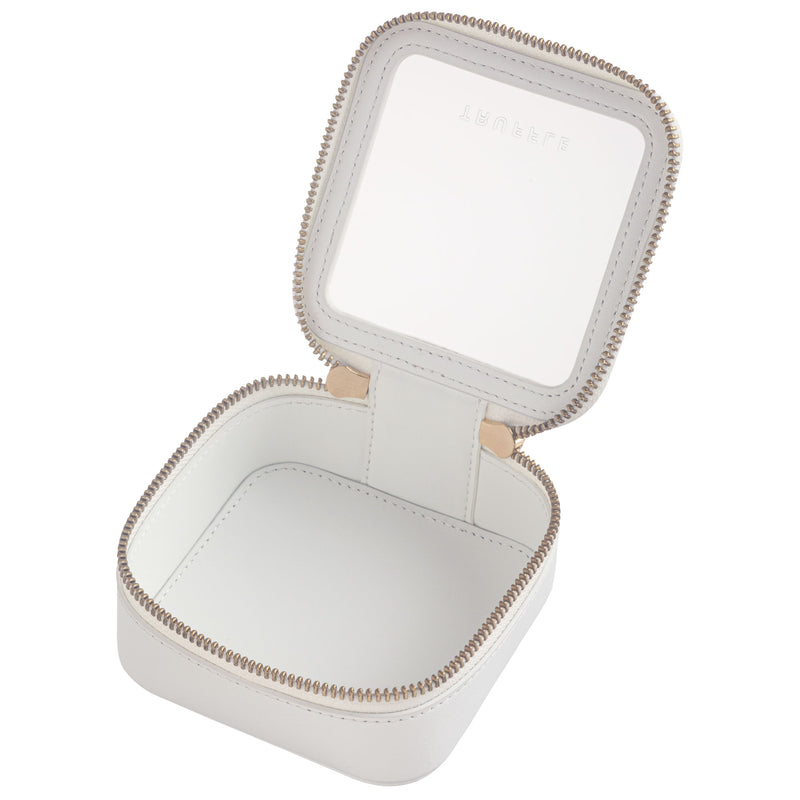 Open view of a Truffle Clarity Petite Case trimmed in white leather, perfect for small essentials.