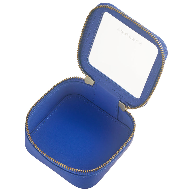 Open view of a Truffle Clarity Petite Case trimmed in sapphire blue leather, perfect for small essentials.