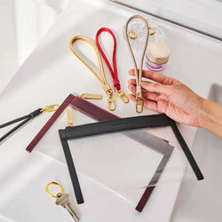 Truffle Wristlet Straps, in various colors, shown with Clarity Clutch Minis.