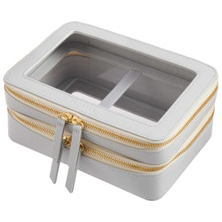 Side view of a Truffle Clarity Jumbo Jetset Case in dove grey leather with two zip-around clear compartments.