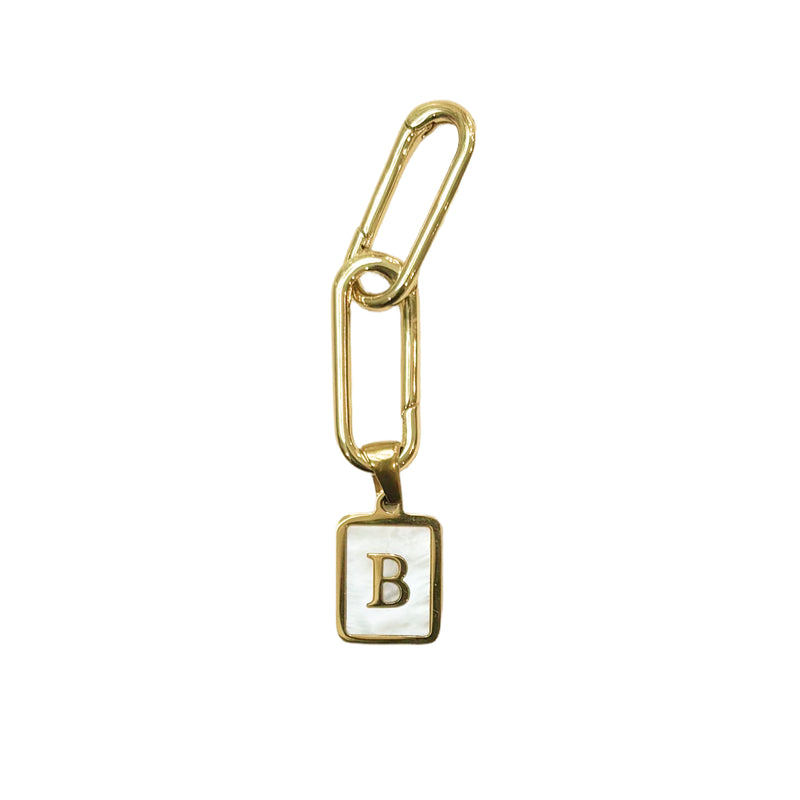 Two gold plated links attached to a small square white enamel charm with a gold border and the letter 'B' in gold, shown on a mother of pearl white background.
