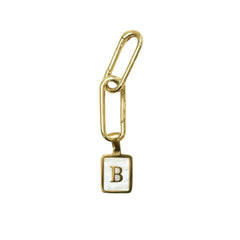 Two gold plated links attached to a small square white enamel charm with a gold border and the letter 'B' in gold, shown on a mother of pearl white background.