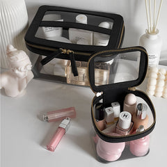Truffle Clarity Jumbo and Mini Train Cases filled with makeup items, sitting on a vanity.
