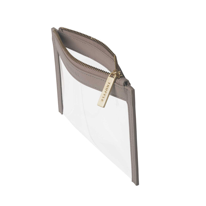 Side view of a Truffle Clarity Clutch Mini, a sleek zippered pouch with clear TPU plastic and Toffee leather trim.
